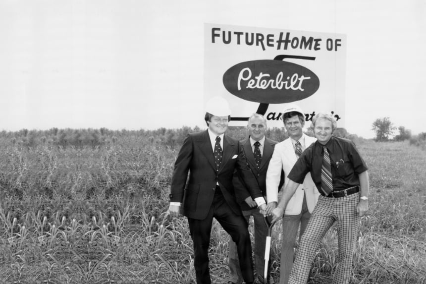 Four men next to sign that says "Future home of Peterbilt"