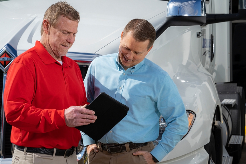 House of Trucks employee showing customer a tablet