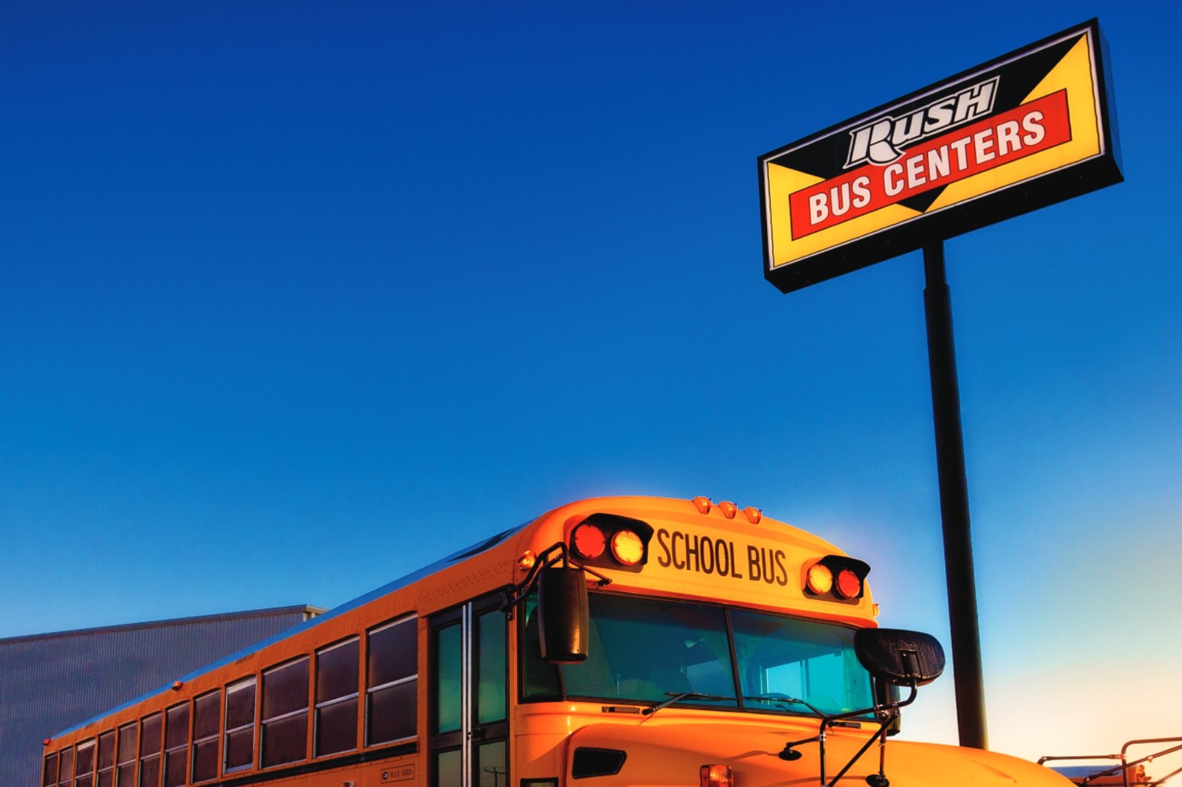 Rush Bus Centers sign and Blue Bird school bus