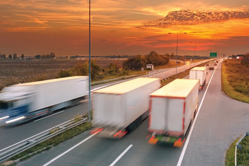 Semi trucks driving down road